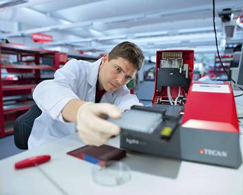 Tecan engineer fixing HydroFlex instrument in, Tecan service center in Grödig, Austria